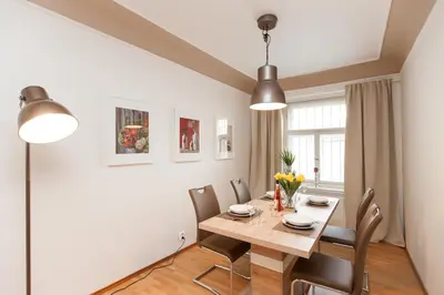 a dining room with a wooden table and chairs at Prague Historic Center Apartments in Prague