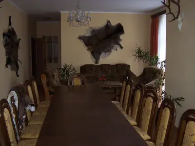 a dining room with a long table and chairs at Penzion U červených vrat in Chudolazy