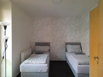 a small room with two beds and a lamp at Penzion V Maštali in Kněževes