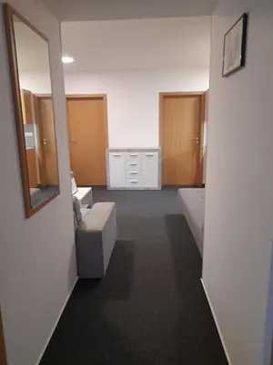 a room with two beds and a mirror at Penzion V Maštali in Kněževes