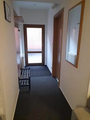 a hallway with a door leading to a room at Penzion V Maštali in Kněževes