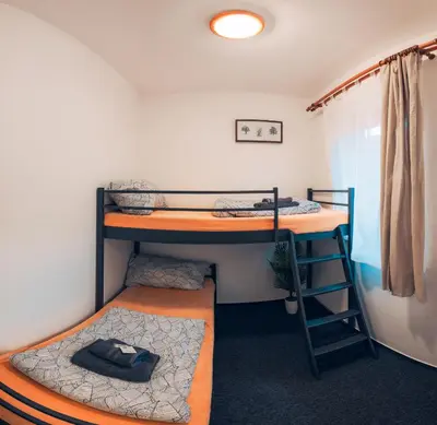 a dorm room with two bunk beds in it at Penzion V Maštali in Kněževes