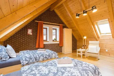 two beds in a room with a attic at Vinný apartmán Rakovník in Rakovník