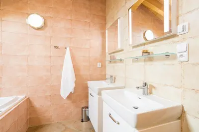 a bathroom with a sink and a mirror at Vinný apartmán Rakovník in Rakovník
