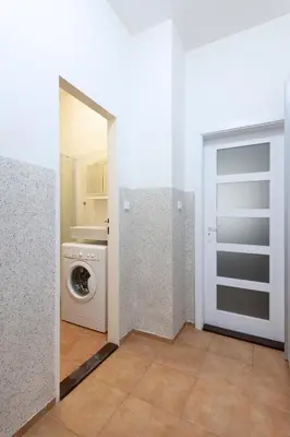 a laundry room with a washing machine and a door at Prague city centre in Prague