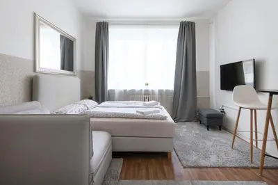 a bedroom with a bed and a couch and a window at Prague city centre in Prague