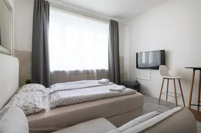 a bedroom with two beds and a large window at Prague city centre in Prague