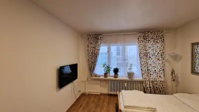 a small bedroom with a bed and a window at Prague city centre in Prague