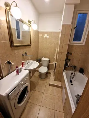 a bathroom with a toilet sink and a washing machine at Prague city centre in Prague