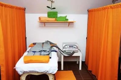 a bedroom with orange curtains and a bed and a desk at Hotel Pod Sluncem in Třebíz