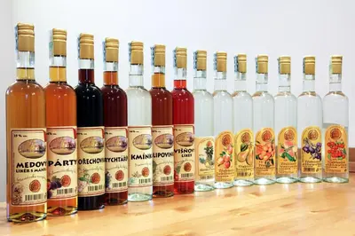 a row of bottles of wine on a table at Hotel Pod Sluncem in Třebíz