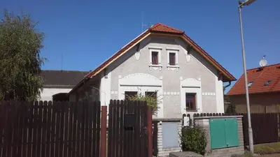 a white house with a fence in front of it at Písková Lhota 8 in Písková Lhota