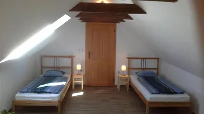 two beds in a room with a attic at Písková Lhota 8 in Písková Lhota