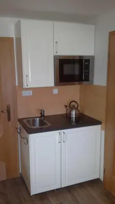 a kitchen with a sink and a microwave at Písková Lhota 8 in Písková Lhota