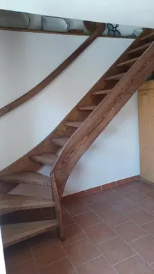 a set of wooden stairs in a room with a tile floor at Písková Lhota 8 in Písková Lhota