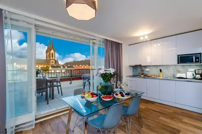 a kitchen and living room with a table with fruit on it at Seven Wishes Boutique Residence by Dwellfort in Prague