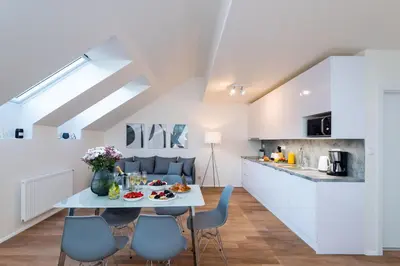 a kitchen and living room with a table and chairs at Seven Wishes Boutique Residence by Dwellfort in Prague
