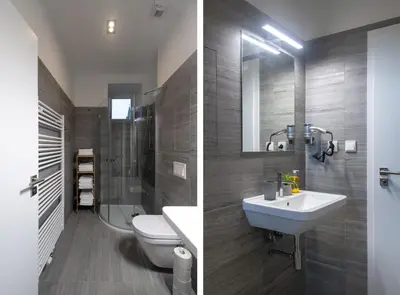 a bathroom with a sink and a toilet and a mirror at Seven Wishes Boutique Residence by Dwellfort in Prague