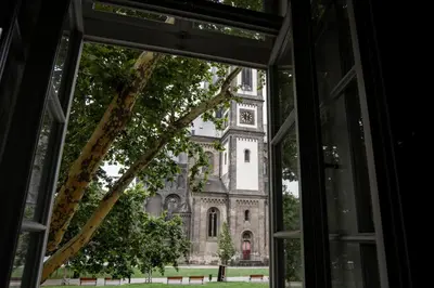 an window view of a church from a building at Apartment Gesse Kollarova in Prague