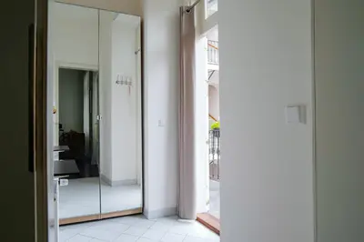 a hallway with white walls and a mirror at Apartment Gesse Kollarova in Prague