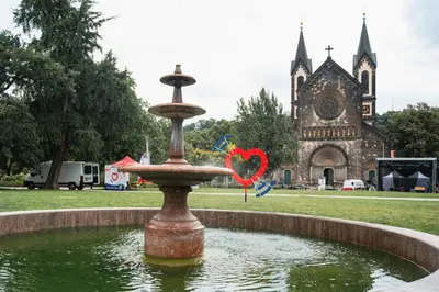 a fountain with a heart in front of a church at Apartment Gesse Kollarova in Prague