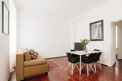 a living room with a table and a couch and a chair at Apartment Gesse Kollarova in Prague