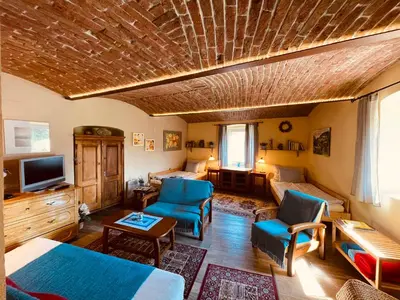 a living room with blue chairs and a couch at Apartmány U kapličky in Kamýk nad Vltavou