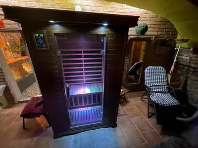 a purple front door of a house with two chairs at Apartmány U kapličky in Kamýk nad Vltavou