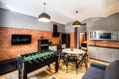 a kitchen and living room with a table with wine bottles at 3BDR RUTERRA Apt with Table Football in Prague