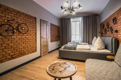 a bedroom with a bed and a bike on the wall at 3BDR RUTERRA Apt with Table Football in Prague