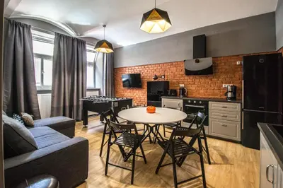 a kitchen and living room with a table and chairs at 3BDR RUTERRA Apt with Table Football in Prague