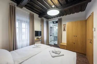 a bedroom with a large white bed and a window at Fancy apartments by Prague Castle in Prague