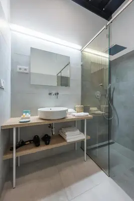 a bathroom with a sink and a glass shower at Fancy apartments by Prague Castle in Prague