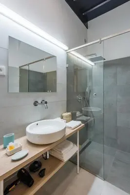 a bathroom with a sink and a glass shower at Fancy apartments by Prague Castle in Prague