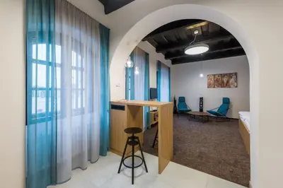 an archway in a room with a bed and a desk at Fancy apartments by Prague Castle in Prague