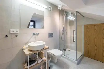 a bathroom with a sink and a toilet and a shower at Fancy apartments by Prague Castle in Prague