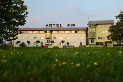 a hotel like building with a field in front of it at Hotel Imos in Prague
