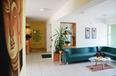 a living room with a blue couch and a table at Hotel Imos in Prague