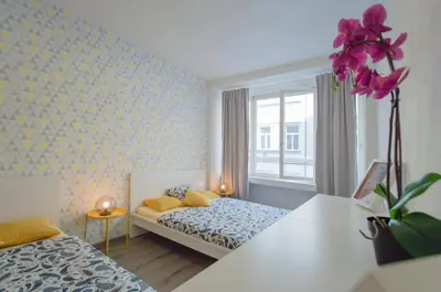 a small bedroom with two beds and a window at Apartment U Pujcovny 6 in Prague