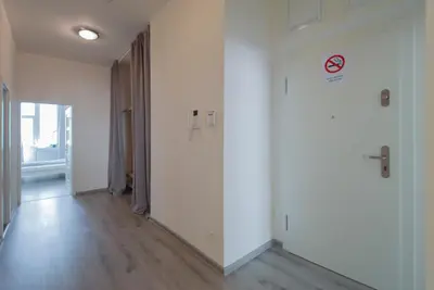 an empty hallway with white walls and wooden floors at Apartment U Pujcovny 6 in Prague