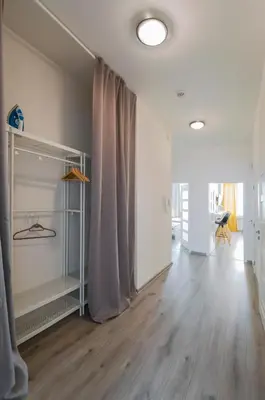 a living room with a curtain and a wooden floor at Apartment U Pujcovny 6 in Prague