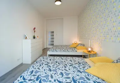 a bedroom with two beds and a brick wall at Apartment U Pujcovny 6 in Prague