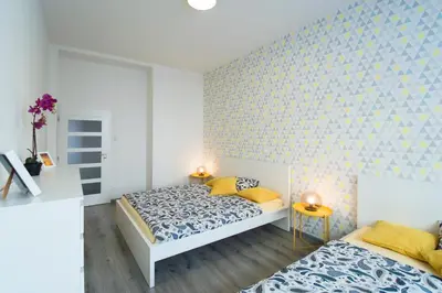 a bedroom with two beds and a brick wall at Apartment U Pujcovny 6 in Prague