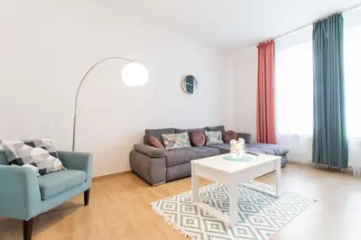 a living room with a couch and a table at Stay Inn Apartments Naplavka in Prague