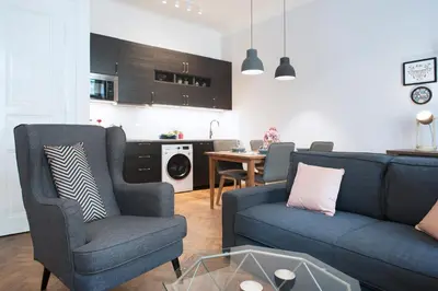 a living room with a couch and chairs and a table at Kent Ridge Loft (Lublanska) in Prague