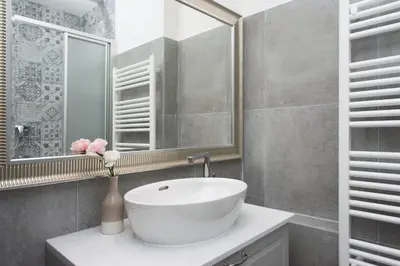 a bathroom with a white sink and a mirror at Kent Ridge Loft (Lublanska) in Prague