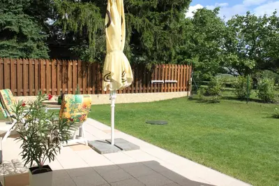a closed umbrella in a yard with a lawn at Lovely apartment, Garden, Parking, Wifi, Netflix in Prague