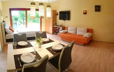 a living room with a dining table and a couch at Lovely apartment, Garden, Parking, Wifi, Netflix in Prague