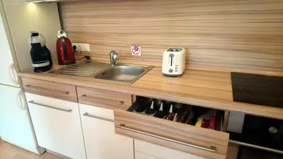 a kitchen with a sink and a counter top at Lovely apartment, Garden, Parking, Wifi, Netflix in Prague