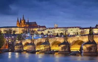 a bridge over the water in front of a city at Lovely apartment, Garden, Parking, Wifi, Netflix in Prague